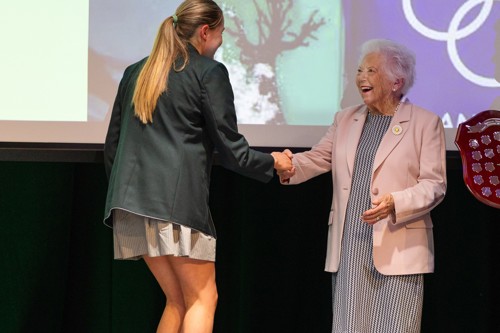 Gweneth Molony, Olympian, shakes hand with MLC student.