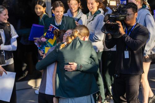 Olympian Indra Brown hugs her friends upon her return to school.